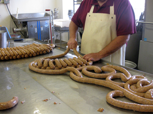 Sausages being hand twisted
